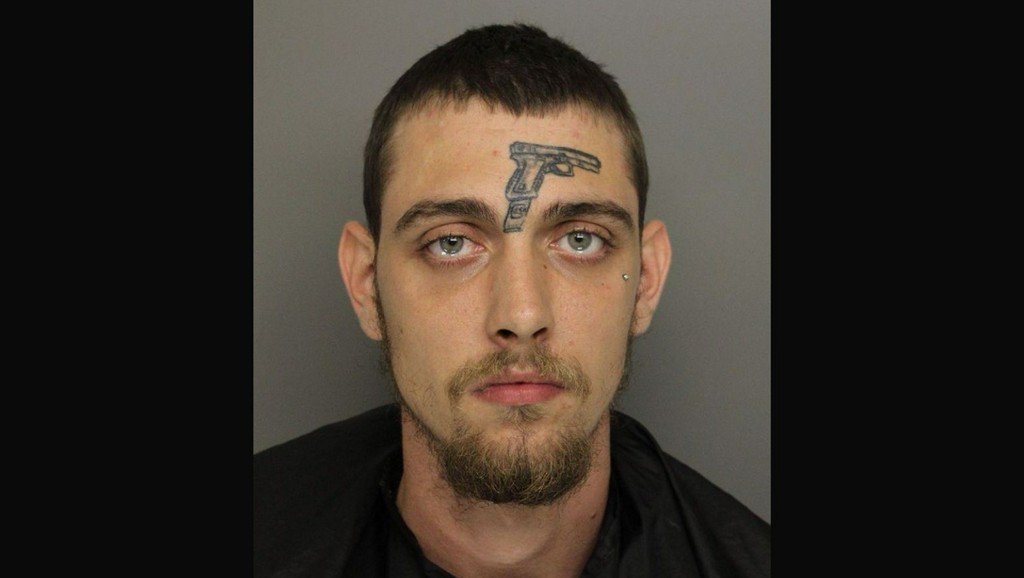 A man with a gun tattooed on his forehead was arrested for unlawful carrying of a firearm, among other charges, according to police in Greenville, South Carolina. Police said Michael Vines is accused of tossing a fully loaded Smith and Wesson .38-caliber revolver into the grass after a recent car wreck near the intersection of Green Avenue and Guess Street.

