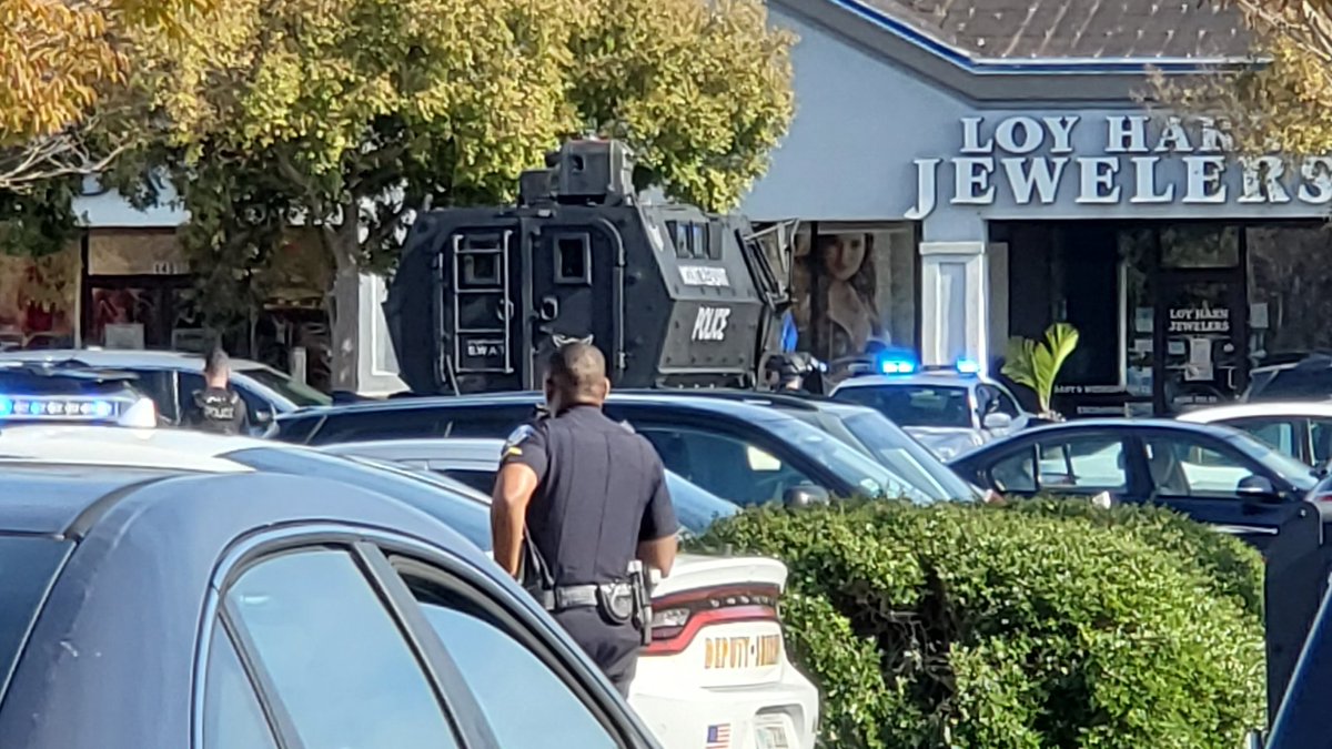 SWAT officers exited their vehicle armed, shooting more projectiles into the suspect car.