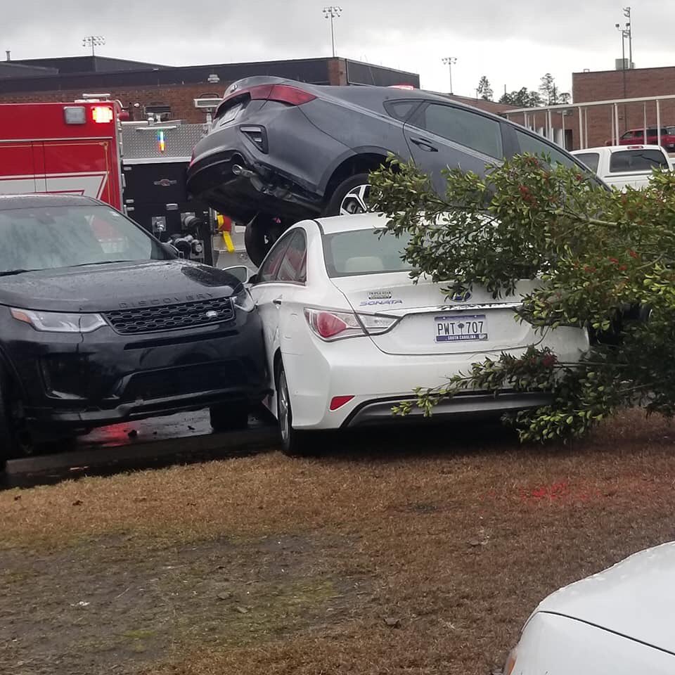 It appears a tornado touched down at Loris High School around 12:45pm this afternoon. No reports of injuries but there was significant damage to cars in the parking lot. 